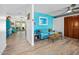 Bright living room features wood floors, blue accent wall, and sliding door to a screened lanai at 1489 Casey Ln, Port Orange, FL 32129