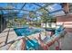Relaxing screened-in pool area with comfortable lounge chairs and a charming stone fire pit for cozy evenings at 1489 Casey Ln, Port Orange, FL 32129