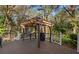 Back deck with pergola provides space to grill and entertain surrounded by natural woodland at 1552 Covered Bridge Dr, Deland, FL 32724