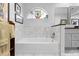 Bright bathroom with a tub, tiled walls, and a decorative window at 1552 Covered Bridge Dr, Deland, FL 32724
