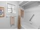 Bright bathroom with white tile, shower and tub combination, and neutral-colored towels at 1552 Covered Bridge Dr, Deland, FL 32724