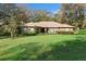 Charming single-story brick home with a well-manicured lawn and mature trees in a serene setting at 1552 Covered Bridge Dr, Deland, FL 32724