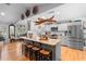 Modern kitchen with a large island, stainless steel appliances, and hardwood floors at 1552 Covered Bridge Dr, Deland, FL 32724