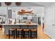 Bright kitchen featuring a large island, modern appliances, and hardwood floors at 1552 Covered Bridge Dr, Deland, FL 32724