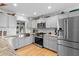 Well-equipped kitchen with stainless steel appliances, hardwood floors, and sleek gray cabinetry at 1552 Covered Bridge Dr, Deland, FL 32724