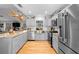 Contemporary kitchen with stainless steel appliances, hardwood floors, and ample counter space at 1552 Covered Bridge Dr, Deland, FL 32724
