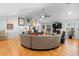 Bright living room with hardwood floors, a ceiling fan, and comfortable wrap around sofa at 1552 Covered Bridge Dr, Deland, FL 32724