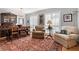 Inviting living room featuring hardwood floors, plantation shutters, and comfortable seating at 1552 Covered Bridge Dr, Deland, FL 32724