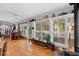 Sunroom featuring many windows, hardwood floors, and access to a wood deck at 1552 Covered Bridge Dr, Deland, FL 32724