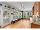 Bright sunroom with wood cabinets, many windows, and hardwood floors at 1552 Covered Bridge Dr, Deland, FL 32724