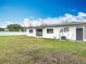 The backyard features a new white fence and exterior entry door at 1579 Brady Dr, Deltona, FL 32725
