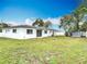 A spacious backyard featuring a white fence, green grass, and a storage shed at 1579 Brady Dr, Deltona, FL 32725