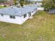 Aerial view of a backyard with a white fence and a gray shingle roof at 1579 Brady Dr, Deltona, FL 32725