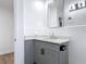 Bathroom features a gray vanity with quartz countertop, updated lighting, and neutral walls at 1579 Brady Dr, Deltona, FL 32725