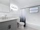 Bathroom features a gray vanity with quartz countertop and shower-tub with updated fixtures at 1579 Brady Dr, Deltona, FL 32725