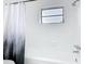 Bathroom features a tub-shower combo, updated fixtures, and a decorative shower curtain at 1579 Brady Dr, Deltona, FL 32725