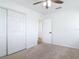 Comfortable bedroom with closet, ceiling fan, and an open doorway at 1579 Brady Dr, Deltona, FL 32725