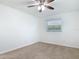 Bright bedroom featuring neutral carpet, ceiling fan, and window with pleasant natural light at 1579 Brady Dr, Deltona, FL 32725