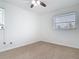 Cozy bedroom with neutral carpet, a ceiling fan, and a bright window at 1579 Brady Dr, Deltona, FL 32725