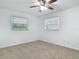 Bright bedroom featuring neutral carpet, ceiling fan, and two windows with pleasant natural light at 1579 Brady Dr, Deltona, FL 32725