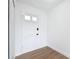 Bright entryway featuring a white front door with glass panes and wood flooring at 1579 Brady Dr, Deltona, FL 32725