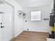 Bright laundry room features laminate flooring, storage shelves, a window, and an efficient water heater at 1579 Brady Dr, Deltona, FL 32725