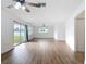 Open-concept living room with wood-look floors and access to backyard at 1579 Brady Dr, Deltona, FL 32725