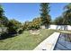 Landscaped backyard features a patio and brick fire pit, enhancing the outdoor living space at 1590 N Page Dr, Deltona, FL 32725