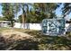 Well-maintained backyard featuring lush greenery and a charming shed with double doors at 1590 N Page Dr, Deltona, FL 32725