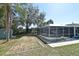 Spacious backyard featuring a screened-in pool area and potential space for lawn games at 1590 N Page Dr, Deltona, FL 32725