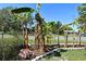 Lush banana trees add a tropical touch to the fenced-in yard, enhancing the property's unique appeal at 1590 N Page Dr, Deltona, FL 32725