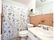 Bathroom displaying seashells themed shower curtain, vintage sink, and decorative elements creating nautical and homey atmosphere at 1590 N Page Dr, Deltona, FL 32725