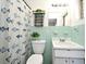 Cozy bathroom featuring turquoise tiling, fish-themed shower curtain, a vintage sink and plants for a homey atmosphere at 1590 N Page Dr, Deltona, FL 32725