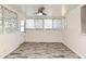 Open dining room with wood-look flooring, a ceiling fan, and bright natural light at 1590 N Page Dr, Deltona, FL 32725