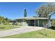 Charming single-story home with a carport and well-maintained lawn at 1590 N Page Dr, Deltona, FL 32725