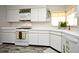 Bright kitchen featuring white appliances, cabinets, countertops, and a wood-look floor at 1590 N Page Dr, Deltona, FL 32725