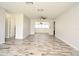 Large living room with an open floor plan, wood-look flooring, and a view of the dining room at 1590 N Page Dr, Deltona, FL 32725