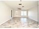 Spacious living room featuring wood-look flooring, a ceiling fan, and abundant natural light at 1590 N Page Dr, Deltona, FL 32725
