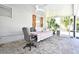 Enclosed patio featuring a ceiling fan, stone floors, and a table with a colorful striped tablecloth at 1590 N Page Dr, Deltona, FL 32725