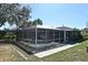 Enclosed pool area featuring a screened enclosure, an attached home and a serene backyard setting at 1590 N Page Dr, Deltona, FL 32725