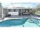 Screened-in pool area with inviting pool, patio space, and partial view of the home's exterior at 1590 N Page Dr, Deltona, FL 32725