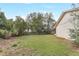 Expansive backyard featuring a well-maintained lawn, mature trees, and a privacy fence, perfect for outdoor activities at 1651 Kenlyn Dr, Longwood, FL 32779