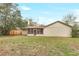 A view of the back of the home featuring a spacious lawn and screened patio at 1651 Kenlyn Dr, Longwood, FL 32779