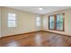 Bright bedroom with three windows and sleek laminate flooring at 1651 Kenlyn Dr, Longwood, FL 32779