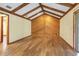 Cozy living room with wood-paneled accent wall and exposed beam ceiling at 1651 Kenlyn Dr, Longwood, FL 32779