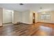 Open living room with hardwood floors, neutral walls, and an adjacent room with tile flooring at 1651 Kenlyn Dr, Longwood, FL 32779