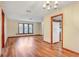 Bright living room featuring hardwood floors, large windows, and a view into the kitchen at 1651 Kenlyn Dr, Longwood, FL 32779
