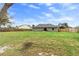 Expansive backyard with a well-kept lawn and wood fence bordering neighboring properties at 1763 Efland Ter, Deltona, FL 32738