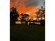 Scenic sunset with the lake reflecting a vibrant orange and gold sky at 1763 Efland Ter, Deltona, FL 32738