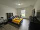 Bedroom with bed, dresser, window and fan at 2235 Rabenton Rd, Deltona, FL 32738